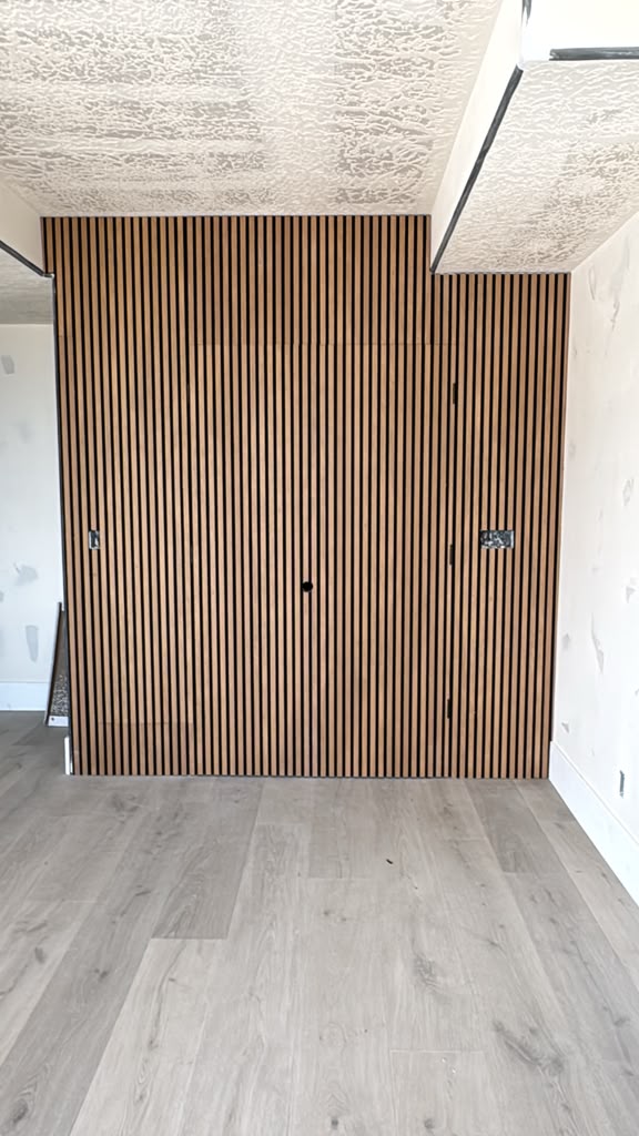 Hidden door with acoustic wood paneling